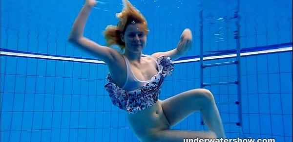  Cute Lucie is stripping underwater